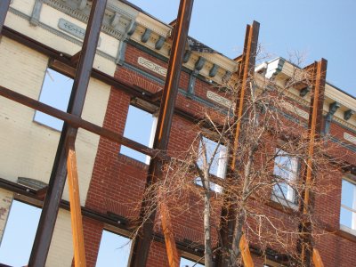 Historic facades along Broadway, supported by steel while construction continues.