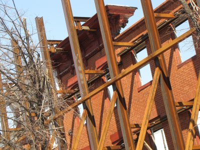 Historic facades along Broadway, supported by steel while construction continues.