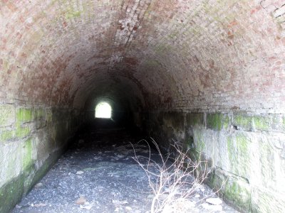 A small tunnel beneath the railroad tracks.  Anyone know what this was used for?