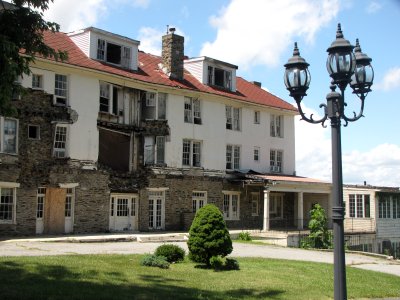 Note the sagging structure and missing facade in the middle of the building.