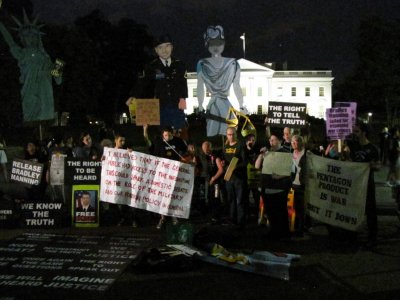It's now completely dark, and the Justice puppet has joined the demonstration.