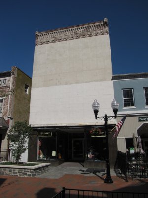 This building, at 160 North Loudoun Street and currently the home of Blind Faith Enterprises, surprised me.  That blank facade struck me as somewhat strange.  Was this a large sign in a past life?  Or is it what's behind that large, blank wall that causes the building to have no windows?  The building housed an A&N at one point, according to an old classified ad that I located, but A&N was never known for large signage.  I have a feeling that this might predate that usage.  Anyone have any idea?