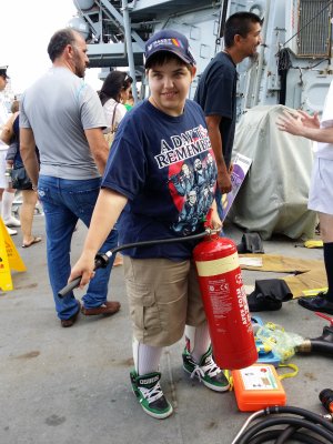 Elyse poses for a photo with one of the fire extinguishers on the deck.