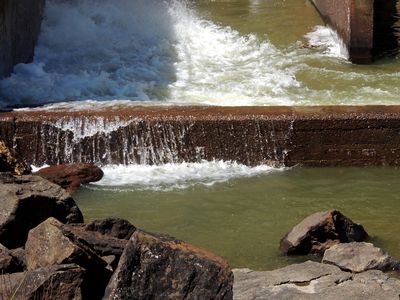 Water flowing over a wall intended to direct water towards the main channel of the Patuxent River.