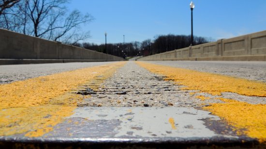 Low view down the middle of Brighton Dam Road, facing Montgomery County.