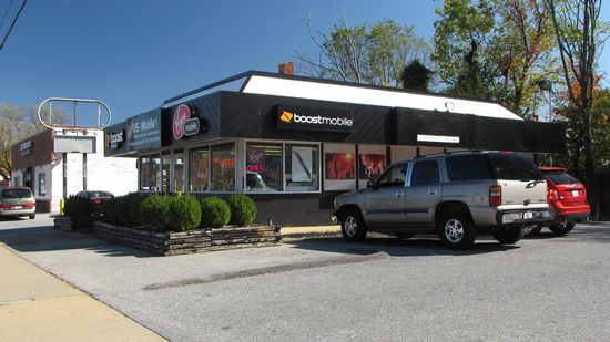 This building is a former Church's Chicken, and would have looked like this as Church's. The oval-shaped sign is also from it's time as Church's, and would have looked like this back then. The building took on its current form between July 2009 and June 2011. Prior to that, it was split between the mobile store and a clothing store. I don't know when the building stopped being a Church's.