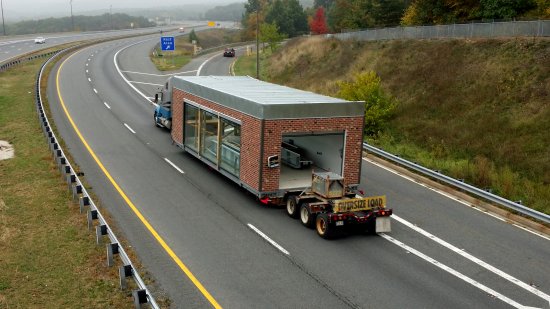 I spotted an escort vehicle for an oversized truck, and was ready to go. I was surprised to see that the load in question was a car wash. This is, as it turns out, a Genesis modular car wash. Based on the appearance, this looks like it is probably destined for a Sheetz location. This is reinforced by the fact that a Sheetz car wash appears on their website.