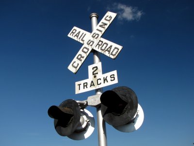 Signal and crossbuck with button copy on the crossbuck's letters