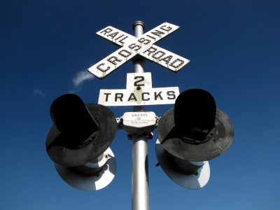 Signal and crossbuck with button copy on the crossbuck's letters