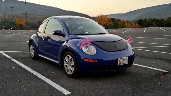 A Volkswagen Bug with pink eyelashes on the headlights.  Okay, then.