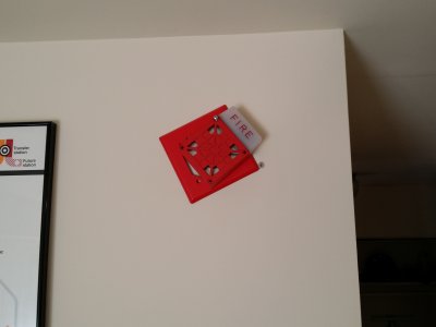 My gutted fire alarm, hanging by one screw before I put the other one in.
