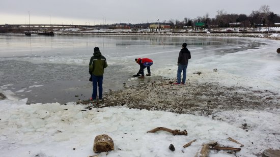 Shoveling ice off of the surface of the Potomac