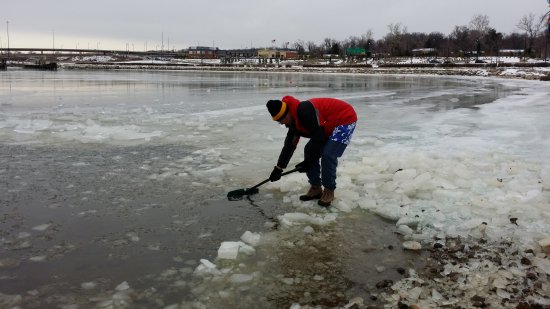 Shoveling ice off of the surface of the Potomac