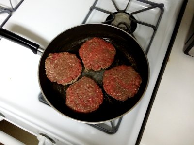 The hamburgers on the stove