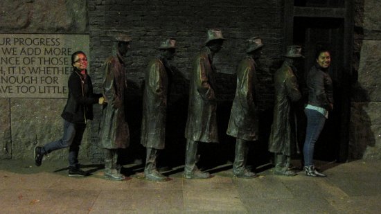 Suzie (at left) and Rocio pose with the row of people waiting in a bread line at the FDR Memorial.