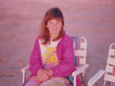 Again in 1995 or 1996, Sis sits in a lawn chair on the beach and watches the sunrise.