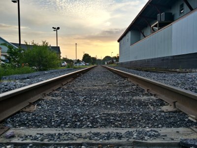 About 100 feet or so north on the rail line, near a second railroad crossing with Winters Street. The building to the right is now a bike shop.