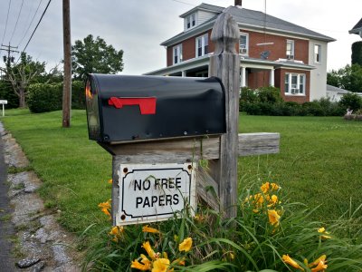 "NO FREE PAPERS" sign on a mailbox