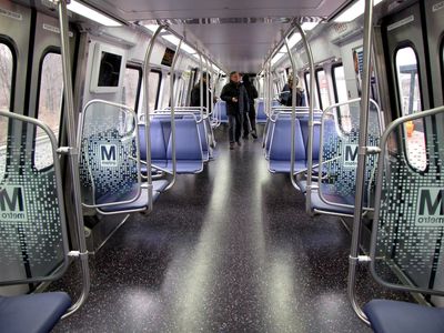 Car 7007, viewed from just past the end doors, facing the blind end of the car.  The seat layout is different than before, with more side-facing seats, and two less rows of seats in the middle of the cars.