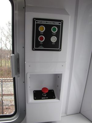Left-side door switches, emergency stop plunger, and PA microphone.  Unlike in previous car series, the controls are not behind a door, and this area contains no seat, and will most likely be unavailable to passengers.