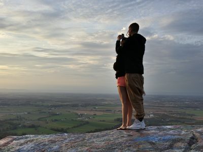 A couple takes photos of the view with their respective phones. View facing approximately northwest.