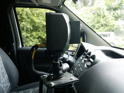 The camera unit inside the van, viewed through the passenger-side window