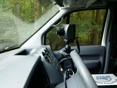 The camera unit inside the van, viewed through the driver-side window