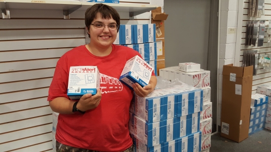 Elyse poses with a stack of SpectrAlert Advance horn/strobes.