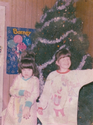 The girls are older in this photo, with "93" written on the back. Assuming December 1993 based on the presence of the Christmas tree.