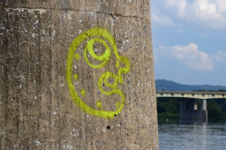 Graffiti face on one of the piers near the shore.