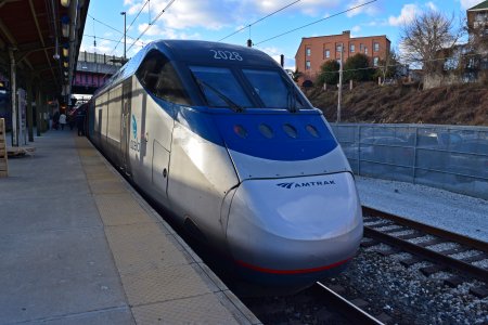 An Acela Express train services the station on its way to DC.