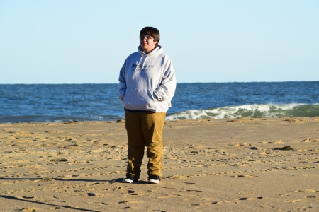 Elyse stands on the beach.