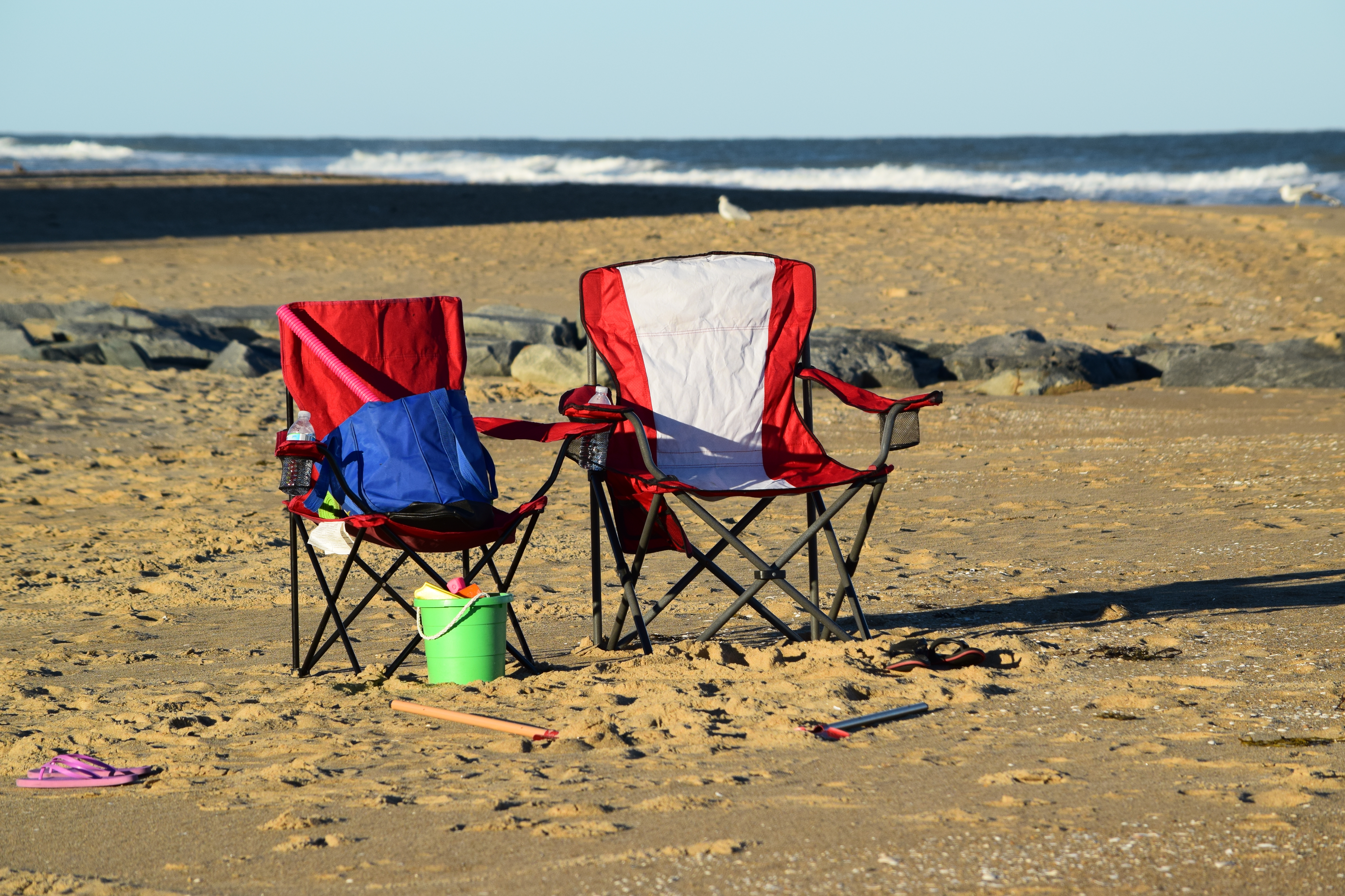 Two chairs set up on the beach.