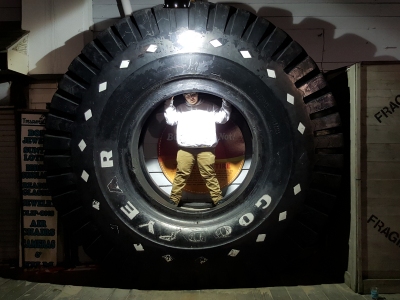 Elyse stands in a giant tire outside the Ripley's building.