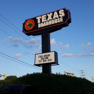 Texas Roadhouse signage in a Shoney's frame