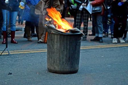 The trash can, on fire.