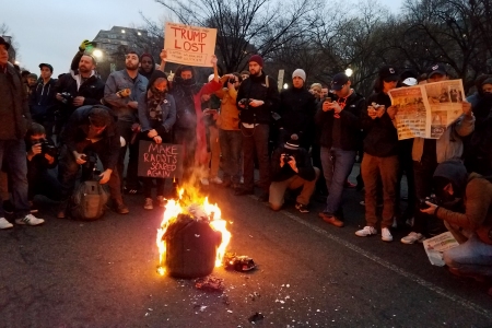 The crowd surrounding the burning trash can at Franklin Square.