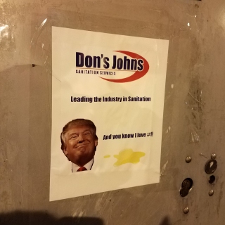 Sign making fun of a controversy where inauguration staff taped over the logo of local company Don's Johns, presumably because of Donald Trump's first name, and reports about Trump's sexual preferences that had recently come out.