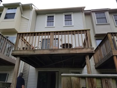 The back of the house.  Note that there is both a deck and a backyard.