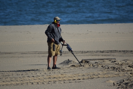 Man using a metal detector.