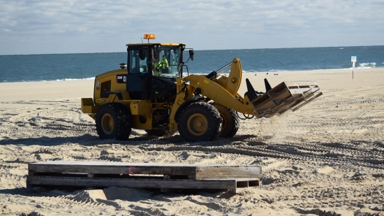 Heavy equipment moving some pallets around.