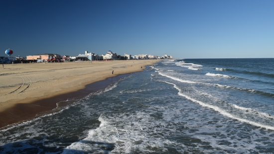 View of the beach and the waves from the fishing pier.