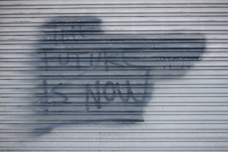 Painted-out "The future is now" graffiti.