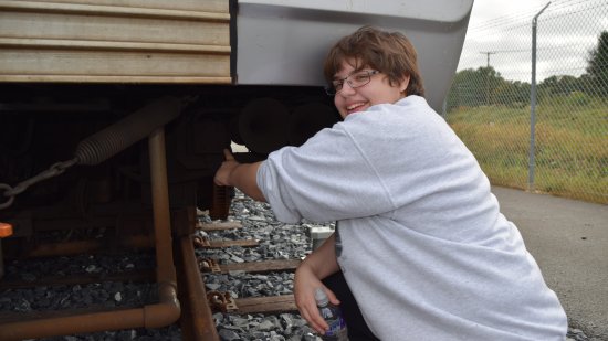 Elyse poses for a photo with the 34T, pointing at it.