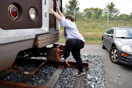 Elyse poses like she's about to climb into the train