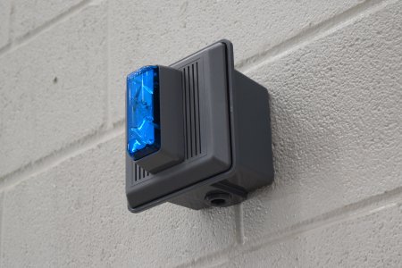 Gray Edwards Integrity horns with blue strobes, used as a simulated fire alarm