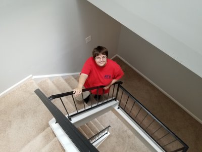 The stairs on this back-to-back townhome.  I'm standing at the third floor level, and Elyse is standing at approximately the second floor level.  As you can see, light and openness makes everything better.