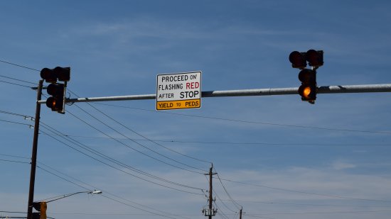 Two signals on a mast arm over East Gude Drive.