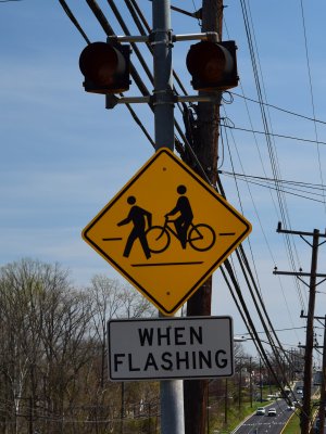 The warning lights approaching the crossing for eastbound traffic.