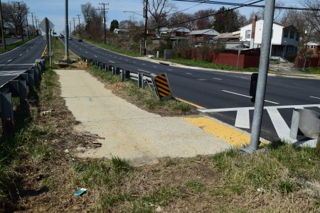 The crosswalks for the two sides of this crossing are offset, and this section of sidewalk in the median connects the two.  As I understand it, it's laid out this way to prevent cyclists from running both sides in a single motion.